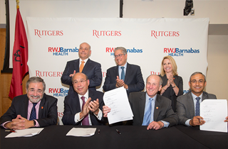 President Barchi, seated with (L-R) RBHS Chancellor Brian Strom, RWJBarnabas Health President and CEO Barry Ostrowsky, and Rutgers Health Group President and CEO Vicente Gracias